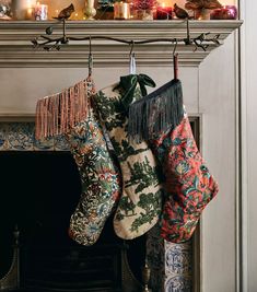 christmas stockings hanging from a fireplace mantel