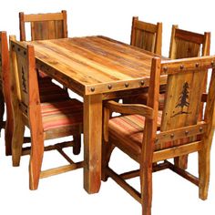 a wooden table with chairs around it and a pine tree painted on the back side