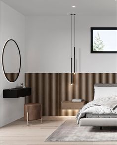 a modern bedroom with wood paneling and white walls, along with an oval mirror on the wall