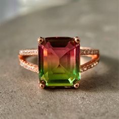 This watermelon tourmaline ring with a stylish split shank is exquisitely crafted in 925 sterling silver with 14K gold plating. Sparkling cubic zirconia is set into the shoulders of the ring band and accentuates the piece. Watermelon tourmaline is believed to have balancing powers that can help you magnify your strengths and release your insecurities. This ring will help you rediscover the meaning if you feel disconnected. For more info check: www.asana.shop 100% Natural Stone From The USA Gemst Luxury Tourmaline Emerald Promise Ring, Luxury Gia Certified Tourmaline Rings, Luxury Tourmaline Jewelry For Healing, Rose Gold Tourmaline Jewelry With Accent Stones, Watermelon Tourmaline Engagement Ring, Displaying Jewelry, Watermelon Tourmaline Ring, Pink Stone Rings, Rings Gemstone