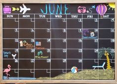 a chalkboard calendar with an image of a flamingo and hot air balloon on it