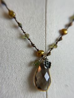 This 18 inch necklace is slightly longer and very pretty on someone with more warm tones to their complexion. Looks great on someone who is richer in color or quite tan, has green eyes or a brunette with warm brown or hazel eyes. Golden freshwater pearls, combined with pinkish bronze crystals and spring green crystals with a warm brown finish, it brightens complexions! Elegant Brown Necklace With Pearl Pendant, Elegant Handmade Brown Pearl Necklace, Brown Pearl Pendant Necklace Gift, Brown Pearl Pendant Necklace As Gift, Brown Pearl Pendant Necklace For Gift, Gift Brown Pearl Pendant Necklace, Elegant Brown Teardrop Necklace, Rosary Jewelry, Smoky Topaz