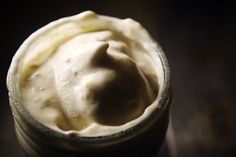 a jar filled with whipped cream sitting on top of a table