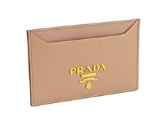 This Prada card holder wallet is crafted from luxurious Vitello Move leather in elegant Cipria beige. The compact design effortlessly slides in your pocket or a slim clutch, with 2 card slots and a center bill slot. Finished with the iconic Prada logo plaque in gold, this wallet is a fusion of luxury and functionality.    Model: 1MC208  Beige Vitello Move leather  Gold-tone hardware  Gold Prada logo plaque  Being fabric interior lining    Two credit card slots    One middle compartment    Measur Prada Card Holder, School Trends, Yellow Watches, Ring Spacer, Michael Kors Fashion, Prada Logo, School Jewelry, Beading Tools, Popular Jewelry