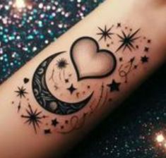 a tattoo on the arm of a woman with stars and a heart shaped moon in the middle