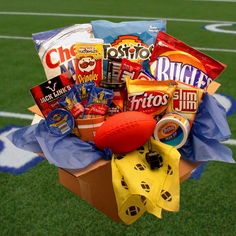 a football gift basket with snacks and candy on the sidelines at a sports field