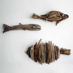 three pieces of driftwood are arranged in the shape of fish