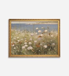 an oil painting of flowers in a field by the water's edge with gold frame