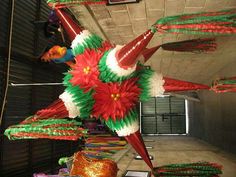 colorful paper flowers are hanging from the ceiling