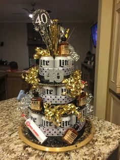 a christmas tree made out of cans and wrapped in gold foil, sits on top of a granite countertop