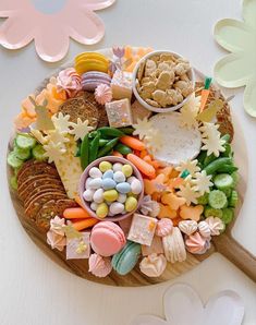 a platter filled with assorted candies and cookies