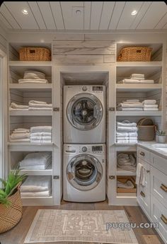 a washer and dryer in a room with lots of white linen on the shelves