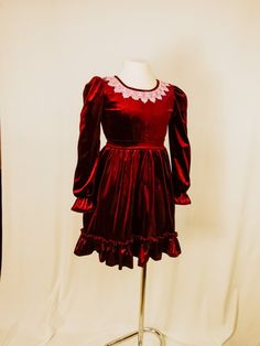 Handmade Velvet burgundy elegant dress in retro style with an asymmetrical bottom for your daughter, granddaughter or younger sister. This dress will dip your girl into the atmosphere of the holiday. The dress is suitable for celebrating a birthday, and for a wonderful Christmas holiday and just for a good mood. on the mannequin dress for a girl 7-9 years old (height 122-134 cm) size 7-9. We offer sizes 4,5,6,7,8,9 Winter Velvet Costume Party Dresses, Velvet Dresses For Winter Costume Party, Fitted Dress For Dress-up Holiday In Fall, Fitted Holiday Dress For Fall Dress-up, Red Velvet Dress For Holidays, Fitted Burgundy Dress For Festive Occasions, Burgundy Long Sleeve Velvet Dress, Marsala Dress, Girls Christmas Dress