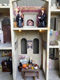 a doll house with lots of furniture and decorations on the shelves in front of it