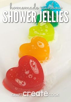 three heart shaped gummy bears sitting on top of a white plate with the words homemade rainbow shower jellies