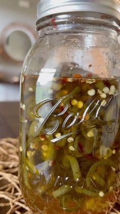 a jar filled with pickles sitting on top of a table