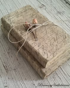 an old book wrapped in twine with writing on it