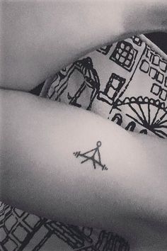 two tattoos on the arms of people with buildings and umbrellas behind them in black and white