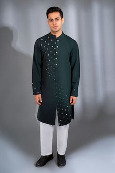 Bottle green full sleeves kurta with booti mirror wave cascading embroidery. Paired with a white pant. - Aza Fashions Fitted Green Kurta For Winter, Designer Green Long Sleeve Kurta, Green Fitted Winter Kurta, Designer Long Sleeve Kurta With Mirror Work, Designer Long Sleeve Kurta With Embroidered Cuffs, Fitted Long Sleeve Kurta With Mirror Work, Green Embroidered Kurta For Winter, Winter Green Embroidered Kurta, Green Embroidered Winter Kurta