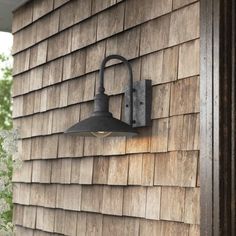 an outdoor light on the side of a house