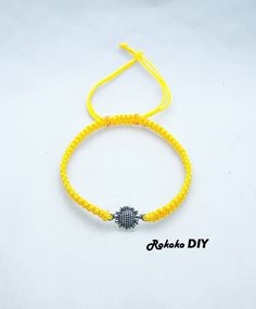 www.etsy.com/shop/RokokoDIY Adjustable personalized charm macrame bracelet - Sunflower - Made to Order. All my products are individually handmade to order. These are perfect gifts for her/him, family, kids, grandparents, aunt, bachelor party, bridal, baby shower, best friends, etc. The bracelet handmade with: -Tibetan Silver (Lead & Nickel Free) connector Sunflower charm - 17 x 10 mm -sturdy quality satin nylon cord - 1mm The bracelet measures 14, 15, 16, 17, 18, 19, 20 and 21 cm. Adult size : opens from 15 to 30 cm (6" to 12''). The knot is ajustable and the jewel adapts to several sizes of wrists. Have approx 5cm hanging threads on the ends to allow it to pass over the wrist and to adjust for different wrist sizes. Simply tighten onto the wrist and trim off the excess. Please measure you Yellow Macrame Bracelet As Gift, Sunflower Charm, Knotted Bracelet, Jewelry Flower, Bracelet Knots, Macrame Bracelet, Macrame Bracelets, Friendship Gifts, Flower Charm