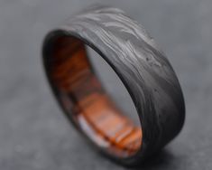 a wedding band with an orange wood inlay