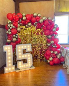 the number fifteen is surrounded by balloons and lights