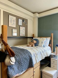 a bedroom with a bed, dresser and shoes on the bottom shelf next to it