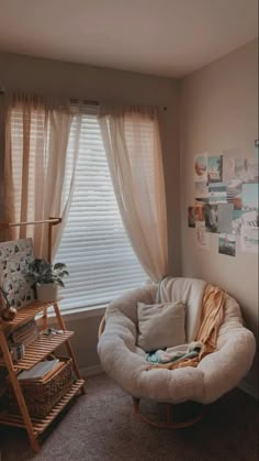 a living room with a chair, window and pictures on the wall in it's corner