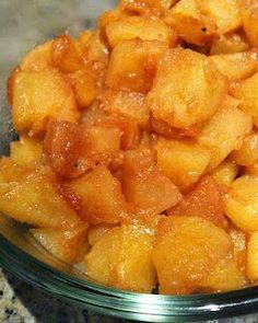 a glass bowl filled with cut up pineapples on top of a granite counter