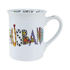 a white coffee mug with the word usa painted on it's side and colorful letters