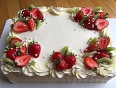 a cake with white frosting and strawberries on top