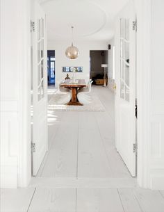 an open door leading into a white room