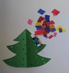 a christmas tree made out of construction paper next to a hole punch cutout with a car on it