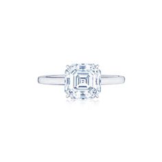 an emerald - cut diamond ring on a white background