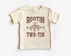 There is a purposeful faded, rustic look to this design.  Looking to customize this design with your little one's name? Check out this listing: https://evergreenkidsco.etsy.com/listing/1756029829 Toddler Tee Description * * * * * * * * * * * * * * * * * * * * * * * * * * * This toddler tee is 100% Airlume combed and ring-spun cotton jersey with a tear-away label for extra comfort. Choose your favorite color out of a big variety, and make unique staples that toddlers will happily wear every day. Rodeo Birthday Party Boy Shirt, Rootin Tootin Two Birthday Boy, This Ain't My First Rodeo It's My Second, Second Birthday Outfit, Country Western Outfits, Horse Halloween, Rodeo Party, Kid Outfits, Western Rustic