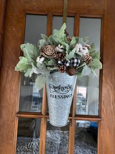 a vase filled with flowers sitting on top of a door