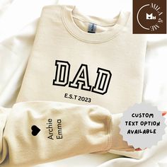 Father's Day mens sweatshirt, tee, best father's day shirt, father's Day jumper gift, Est Year dad sweater, new dad,classic Dad bold print  ORDERING 1- Please review all the information provided before placing an order 2- Select the sweatshirt design and size by using the drop down menu. 3- Select the color of the shirt using the following drop down menu. 4- Add personalisation as per instructions  5- Need more items? If you like to add more items to your order please press the back button and r Customizable Long Sleeve Sweatshirt For Father's Day, Father's Day White Sweatshirt Gift, Customizable Long Sleeve T-shirt For Father's Day, Personalized Crew Neck Tops For Father's Day, Father's Day Casual Sweatshirt With Name Print, Casual Father's Day Gift Sweatshirt, Father's Day Casual Sweatshirt Gift, Father's Day Casual Graphic Sweatshirt, Father's Day White Graphic Print Sweatshirt