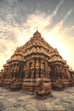 an intricately carved stone structure in the middle of a courtyard