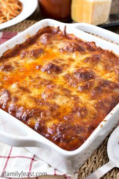 a casserole dish with cheese and meat in it