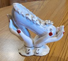 a ceramic figurine is sitting on a wooden table