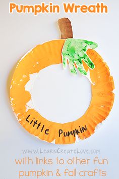 a paper plate pumpkin wreath with the words little pumpkin painted on it and a handprinted palm tree