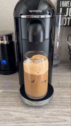 an espresso machine with liquid in it on a table