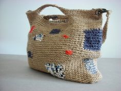 a handbag made out of woven material with blue, red and white designs on it