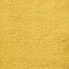 a yellow wall that is very bright and has some paint on it's surface