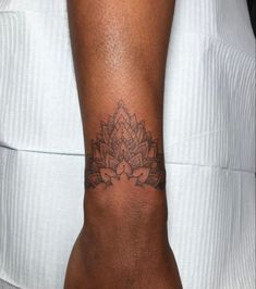 a woman's arm with a tattoo on it that looks like a lotus flower