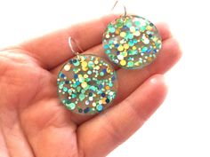 Love these circle colorful sparkle confetti resin dangle earrings! You will get so many compliments when you wear these! The earrings are made with clear resin and large sparkly glitter to make a round shape (38mm) long and wide. The ear wires are solid sterling. The glitter placement may not be the EXACT way in the photos, but will look very similar. Please take these earrings off when jumping in water. They are water resistant, but will last longer if kept out of being drenched by water. Hypoallergenic Round Earrings For Party, Party Earrings With Resin Ear Wire, Party Earrings With Ear Wire In Resin, Multicolor Circle Earrings For Party, Multicolor Hypoallergenic Party Jewelry, Multicolor Hypoallergenic Jewelry For Party, Hypoallergenic Resin Jewelry For Parties, Multicolor Round Earrings For Birthday, Hypoallergenic Multicolor Earrings For Parties