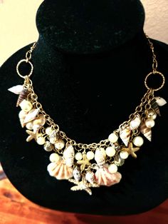 This beautiful vintage Amrita Singh Sea Shell necklace has redefined affordable luxury. Faux pearls have been combined with sea shells on a gold tone chain to create one of the designer's most stunning necklace. The necklace combines old world charm and elegance with today's chic fashion trends. Be ready for the 2024 holiday season, with this double strand necklace. This accessory will transport any daytime outfit from casual to evening elegant. Item was previously owned, but not worn. The neckl Sea Shell Necklace, Amrita Singh, Double Strand Necklace, Seashell Necklace, Shell Necklace, Old World Charm, Stunning Necklace, Shell Necklaces, Chic Fashion