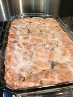 a casserole in a glass dish sitting on top of a stove