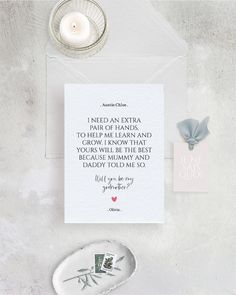 a white card with a quote on it next to a candle and some other items